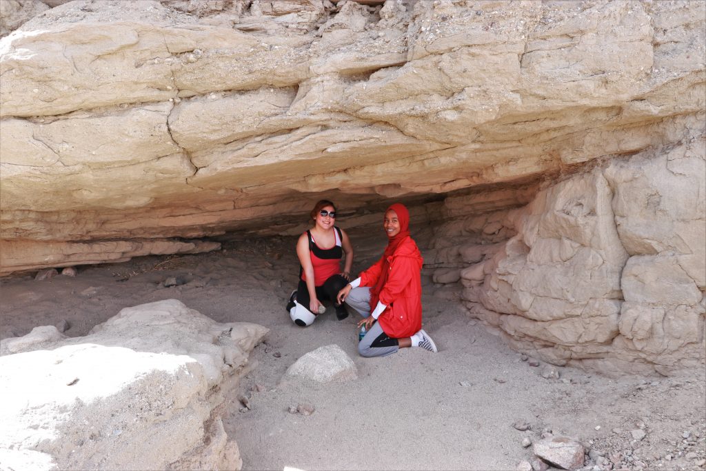 two girls under rock