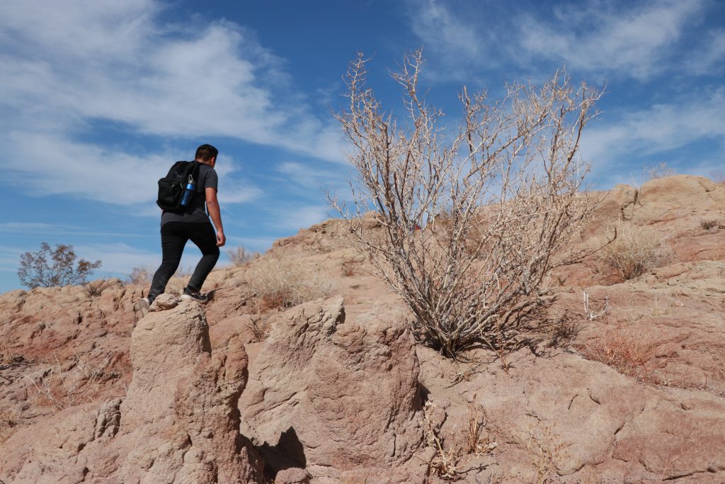 lone person climbing rocks