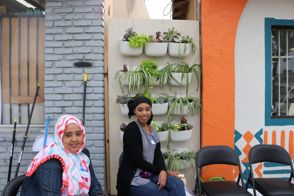 women in front of plant wall
