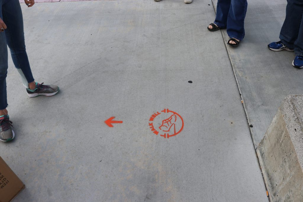 cemented painted walking sign