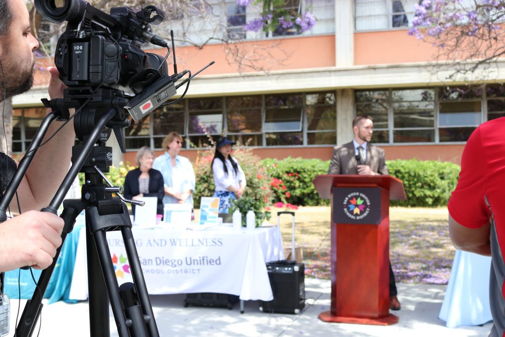 film camera pointing at podium