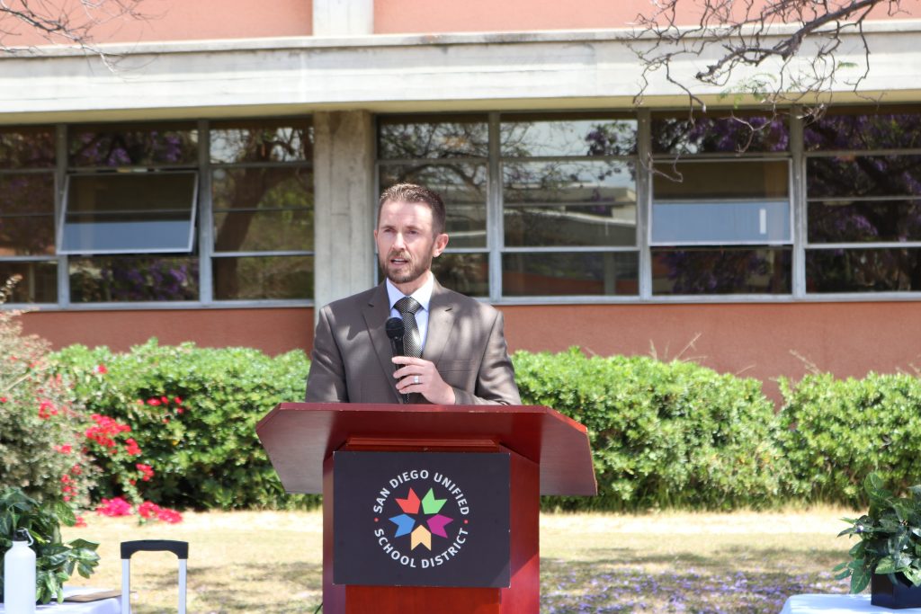 person speaking behind podium
