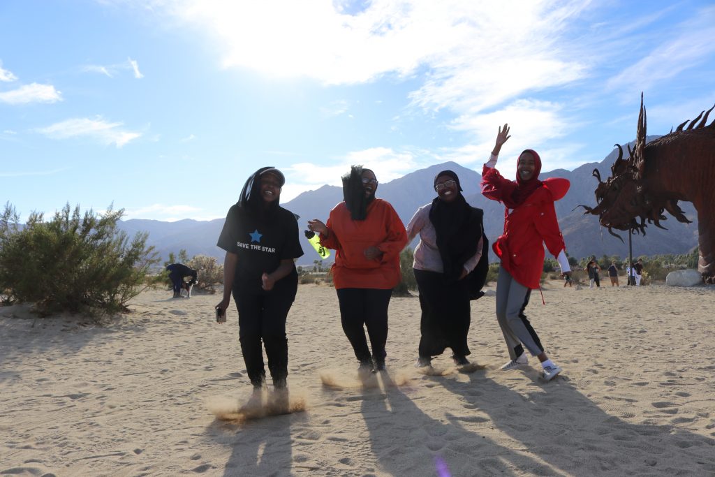four ladies on sand