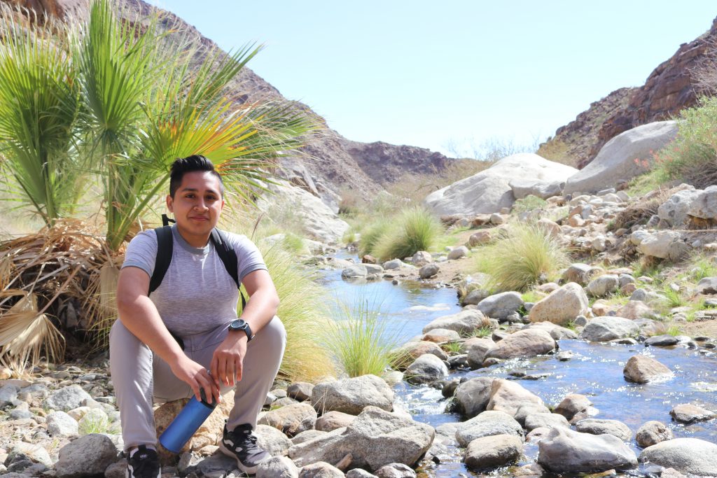 person sitting by creek