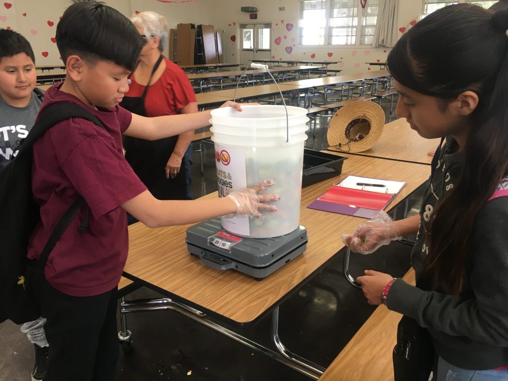students with compost bucket