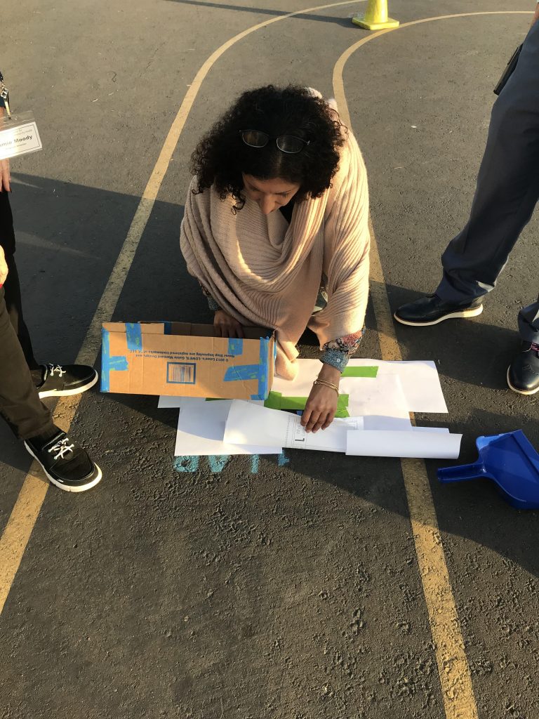 woman stenciling lap marker on cement