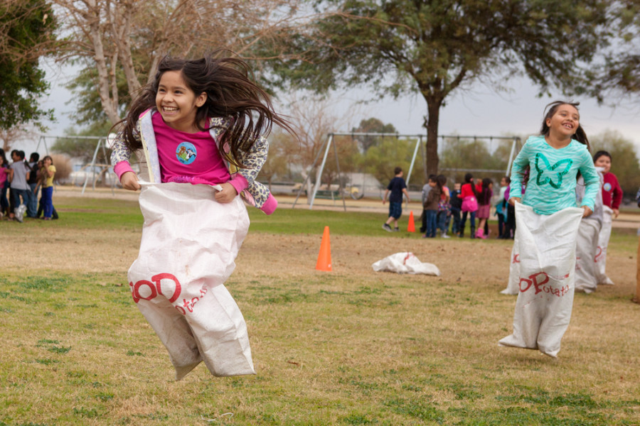 children in potato sack race