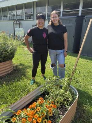 Christina Ng and Courtney Lamb in the school garden